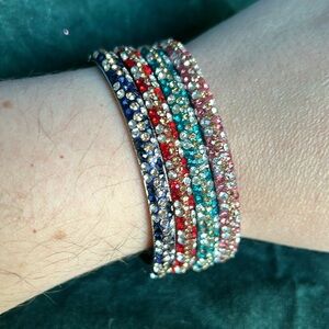Four colorful beaded silver Indian bangles.